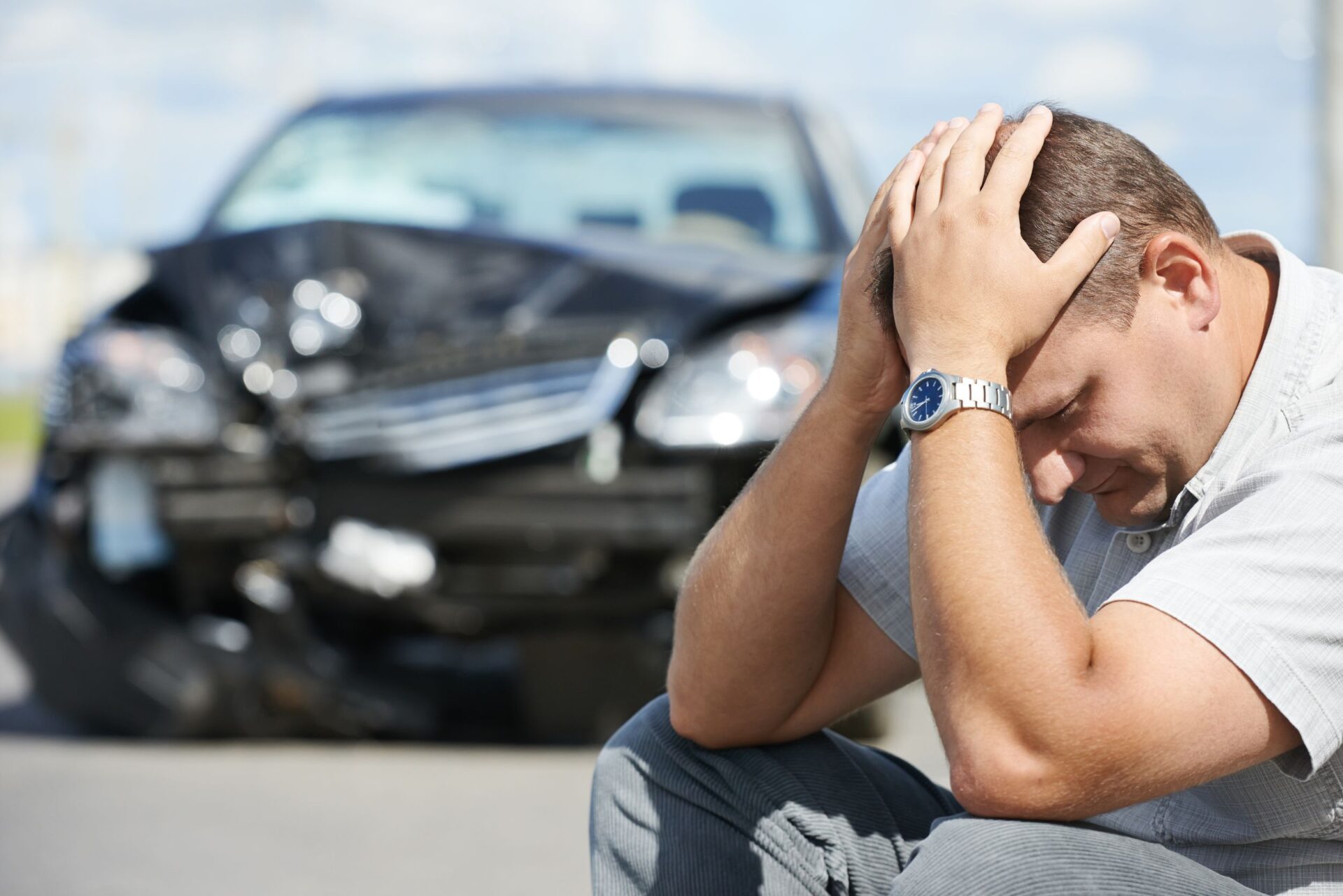 21810631_m adult upset driver man in front of automobile crash car collision accident in city road